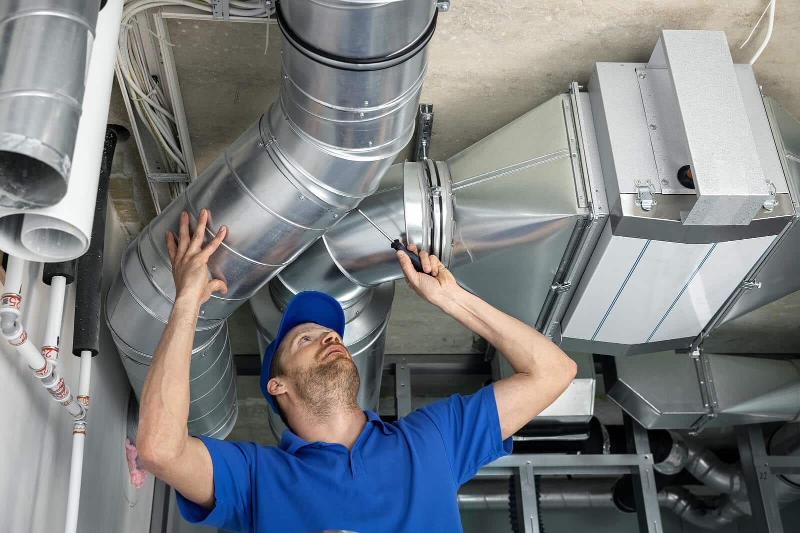 HVAC technician inspecting and repairing air ducts in Lompoc