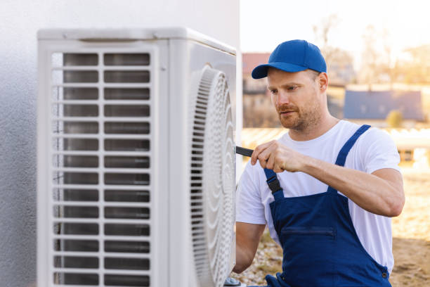 HVAC technician servicing an outdoor air conditioner in Lompoc
